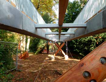 Smaller columns are positioned to support ramps at either end of the walkway