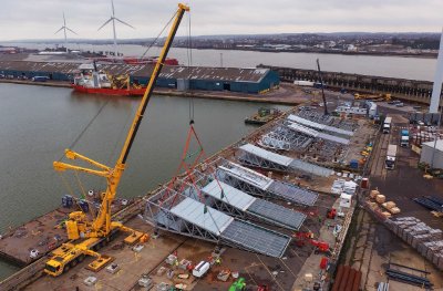 Due to onsite constraints, roof trusses are assembled at Tilbury Docks before being transported to site by barge