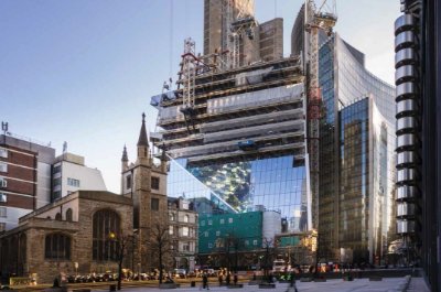 The glass cladding installation progresses behind the steel erection