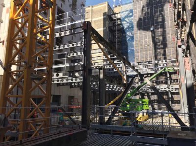 Within the retained façade, a steelwork structure is being erected