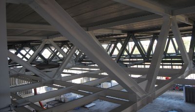 Trusses span the sports hall and support the football pitch above