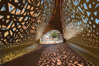The architectural design consists of perforated steel plate with a gold paint finish