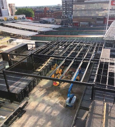 An independent roof structure covers the containers
