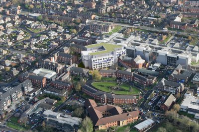 Impression of the completed extension (with green roof) sitting next to the existing hospital