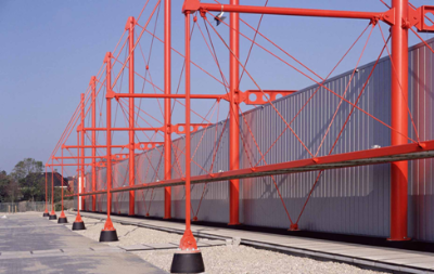 Cable stayed roof beams of a storage facility