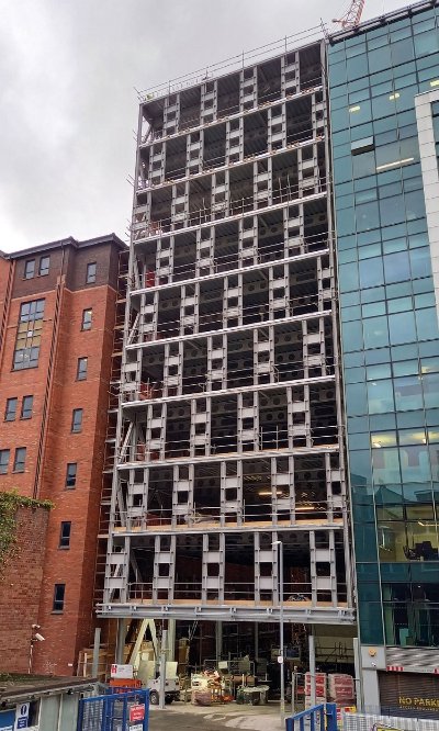 A 10-storey steel-framed wing complements the main elevation's hybrid design
